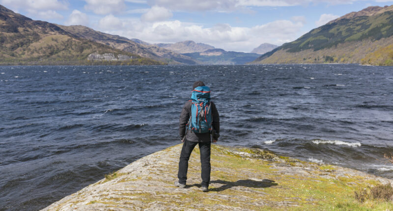 Walker taking in the view of Loch Lomond from Rowardennan