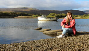 Melanie from the Absolute Escapes team sitting by River Lochy, Fort William (credit - Melanie Grandidge)