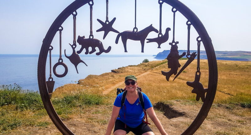 Sine from the Absolute Escapes team with the Charm Bracelet sculpture at Saltburn on the Cleveland Way by artist, Richard Farrington (credit - Sine Birkedal Nielsen)