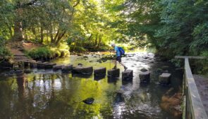 Walking across the stepping stones at Egton Bridge