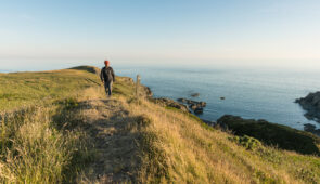 Hiker on the Southern Upland Way at Killantringan, near Portpatrick