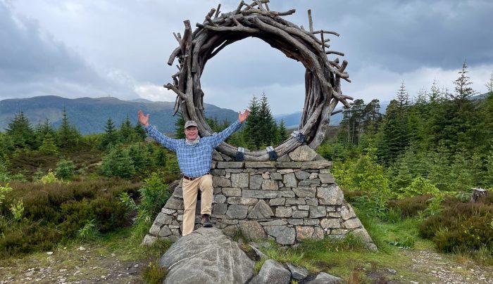 An Absolute Escapes walker at the Viewcatcher sculpture on the trail