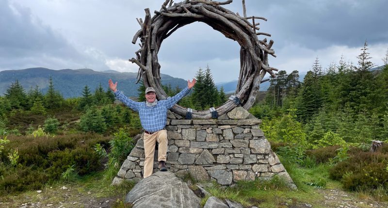 An Absolute Escapes walker at the Viewcatcher sculpture on the trail