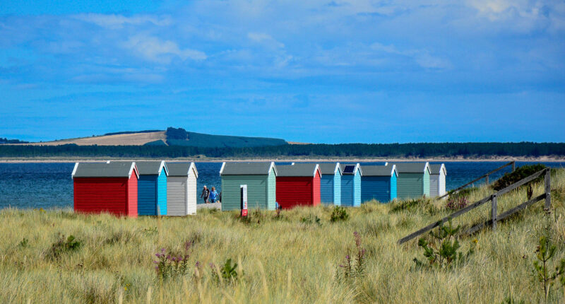 Colourful beach huts at Findhorn Beach