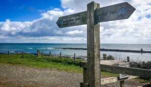 Northumberland Coast Path waymarker near Dunstanburgh Castle