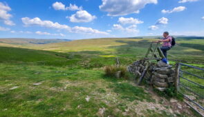 An Absolute Escapes client climbing over a stile on the Dales Way (credit - Marianne Engelshove)