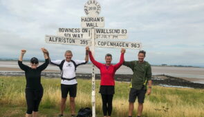 Absolute Escapes clients at the signpost near Bowness-on-Solway (credit - Martin Arvesen)