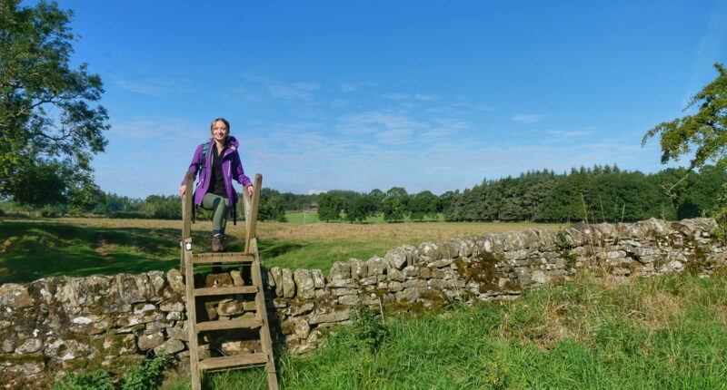 Daisy from the Absolute Escapes team at a stile near Walwick