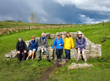 Walkers at the Temple of Mithras on Hadrian's Wall