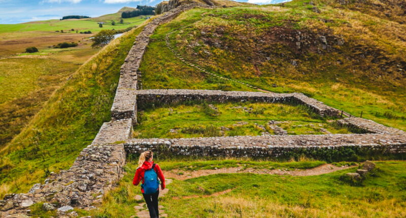 Zoe from the Absolute Escapes team walking through Milecastle 39 on Hadrian's Wall Path