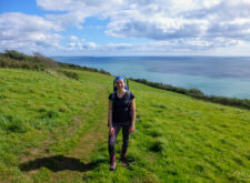 Megan from Absolute Escapes walking towards Rame Head