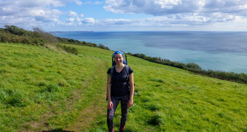 Megan from Absolute Escapes walking towards Rame Head