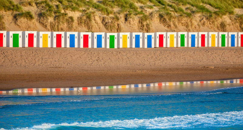 Colourful beach huts at Woolacombe beach