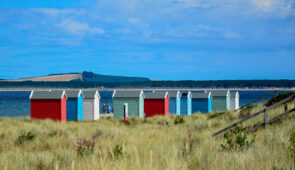 Colourful beach huts at Findhorn Beach