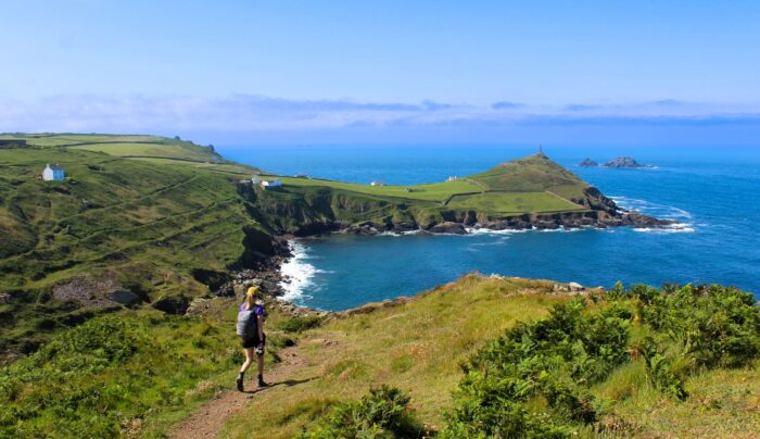 Zoe from the Absolute Escapes team walking towards Cape Cornwall