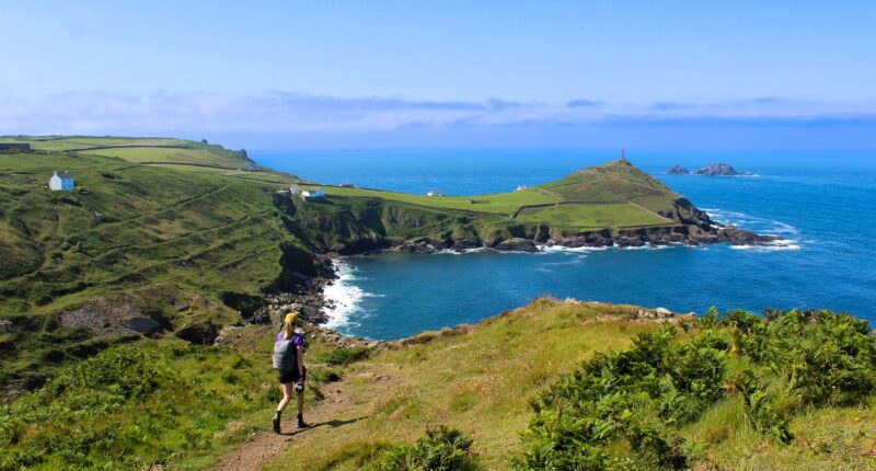 Zoe from the Absolute Escapes team walking towards Cape Cornwall