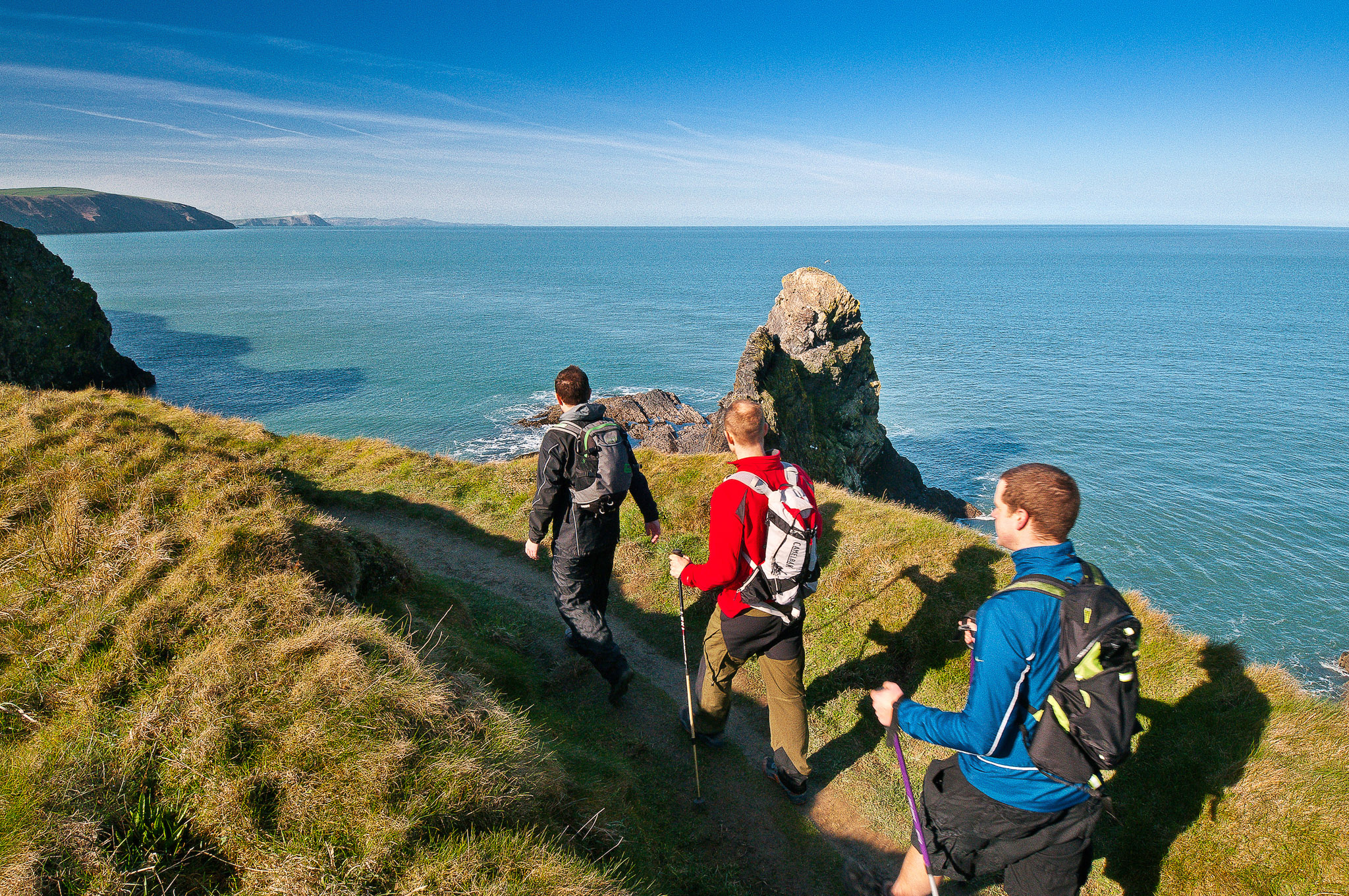 Three walkers on Pembrokeshire Wales Coast Path
