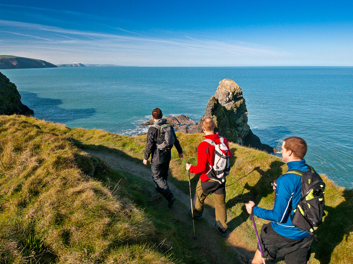 Three-walkers-on-Pembrokeshire-Wales-Coast-Path