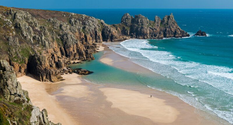 Pedn Vounder Beach, backed by the Logan Rock, Cornwall