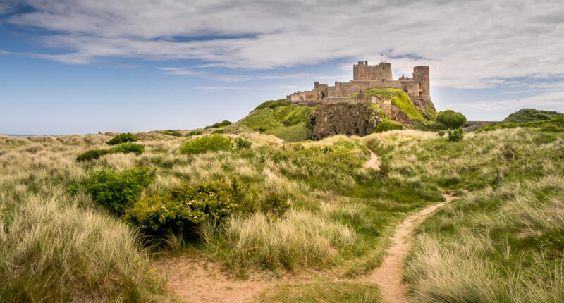 Bamburgh Castle through the sand dunes