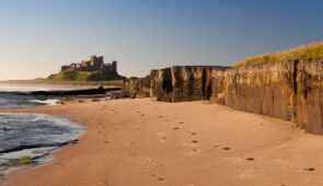 Sandy beach looking towards Bamburgh Castle