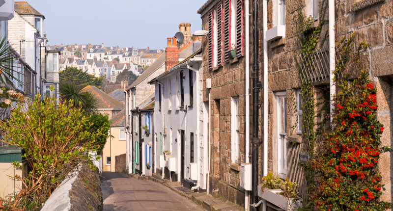 Narrow Cornish lane lined with pretty cottages in the town of St Ives
