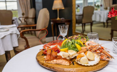 A platter of seafood in the middle of a dinner table in a high-end Scottish restaurant