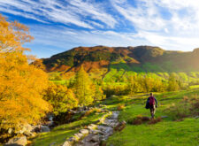 Male hiker exploring the Great Langdale valley in the Lake District, famous for its glacial ribbon lakes and rugged mountains.