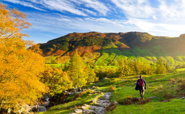 Male hiker exploring the Great Langdale valley in the Lake District, famous for its glacial ribbon lakes and rugged mountains.