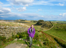 Daisy from the Absolute Escapes team in front of the view near Housesteads