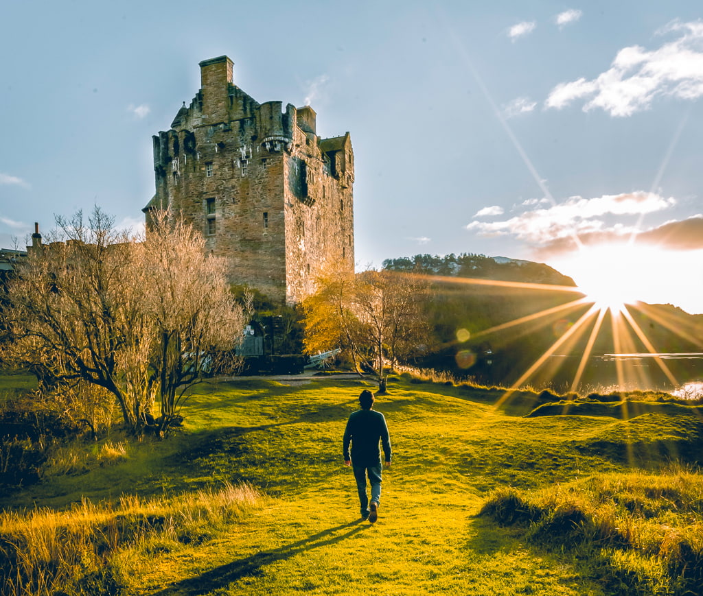 Man approaching Eilean Donan Castle in Scotland