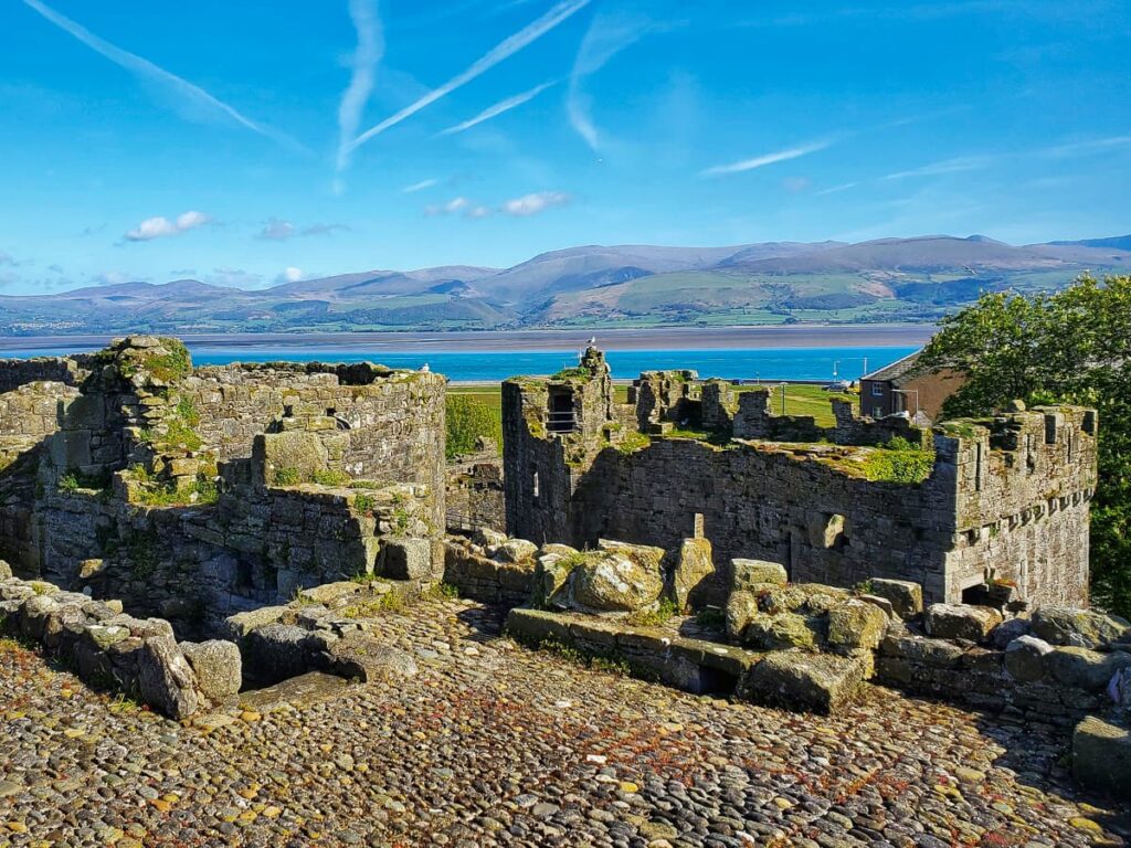 Medieval Beaumaris Castle with panoramic views of the sea and mountains along the Anglesey walking route.