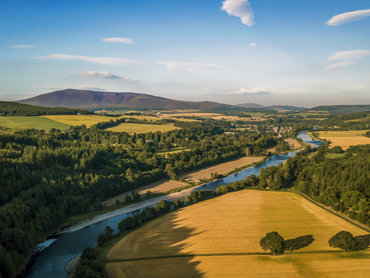 Aerial view of Aberlour town and River Spey in Speyside - scenic whisky country destination featured in road trip itineraries in Scotland's northeast region