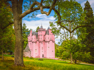 Craigievar Castle's distinctive pink turrets in Aberdeenshire - fairytale Scottish castle featured in road trip itineraries in Scotland along the historic Castle Trail