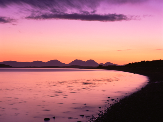 Sunset over the Sound of Gigha towards the Paps of Jura, reflecting Absolute Escapes’ promise of peace of mind and stress-free travel.