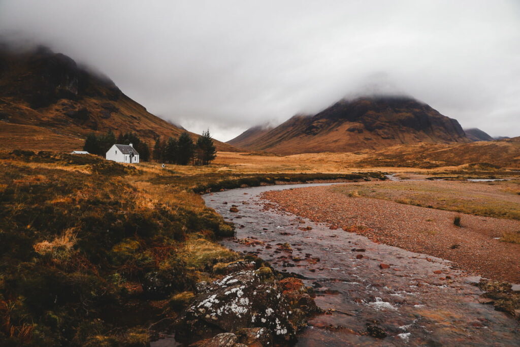 Dramatic mountains and a winding river in Glencoe, captured from the West Highland Way – moody West Highland Way photos.