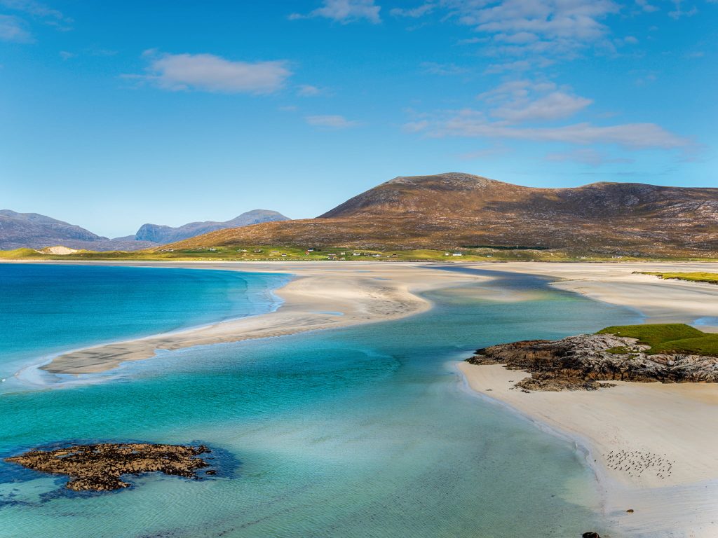 Blue skies over Luskentyre Beach on the Isle of Harris, Scotland, one of the prettiest places in the UK during summer