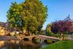 Bourton-on-the-Water, located in the Cotswolds Area of Outstanding Natural Beauty in Gloucestershire, is a popular, picturesque village renowned as the "Venice of the Cotswolds"