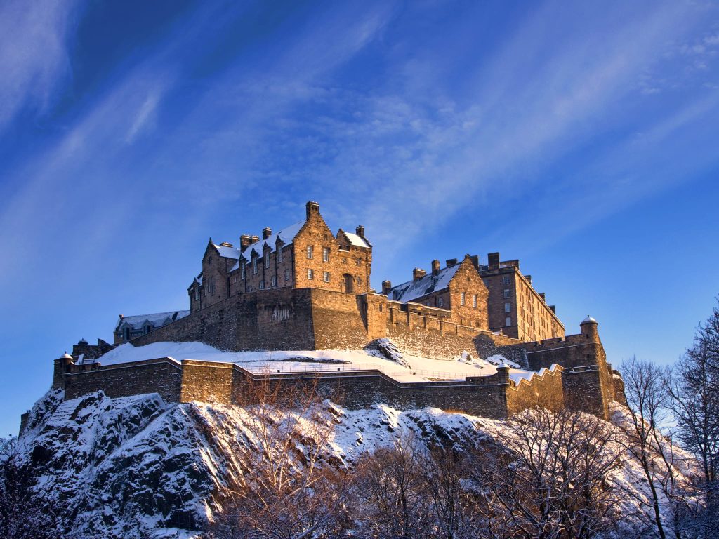 Edinburgh Castle in winter with snow-dusted rooftops, showcasing Scotland’s historic capital during the UK winter season