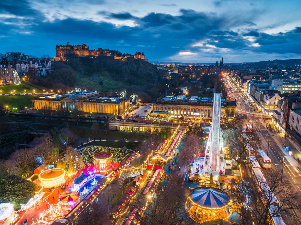 Edinburgh Christmas Market in winter, showcasing festive travel experiences and where to go in the UK in the winter months.