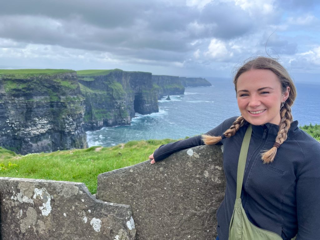 Kate in front of the Cliff of Moher - a dramatic highlight of the Wild Atlantic Way driving route.