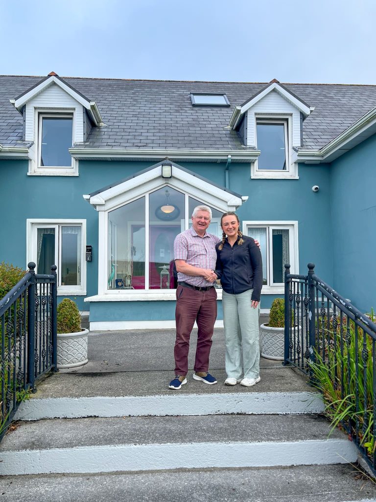 Our Senior Travel Specialist, Kate, and accommodation host Dermot, in front of The Lighthouse Bed & Breakfast in Dingle on the Wild Atlantic Way
