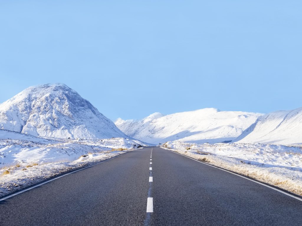 Snowy winter landscape along the road through Glencoe, Scotland, during the colder UK seasons