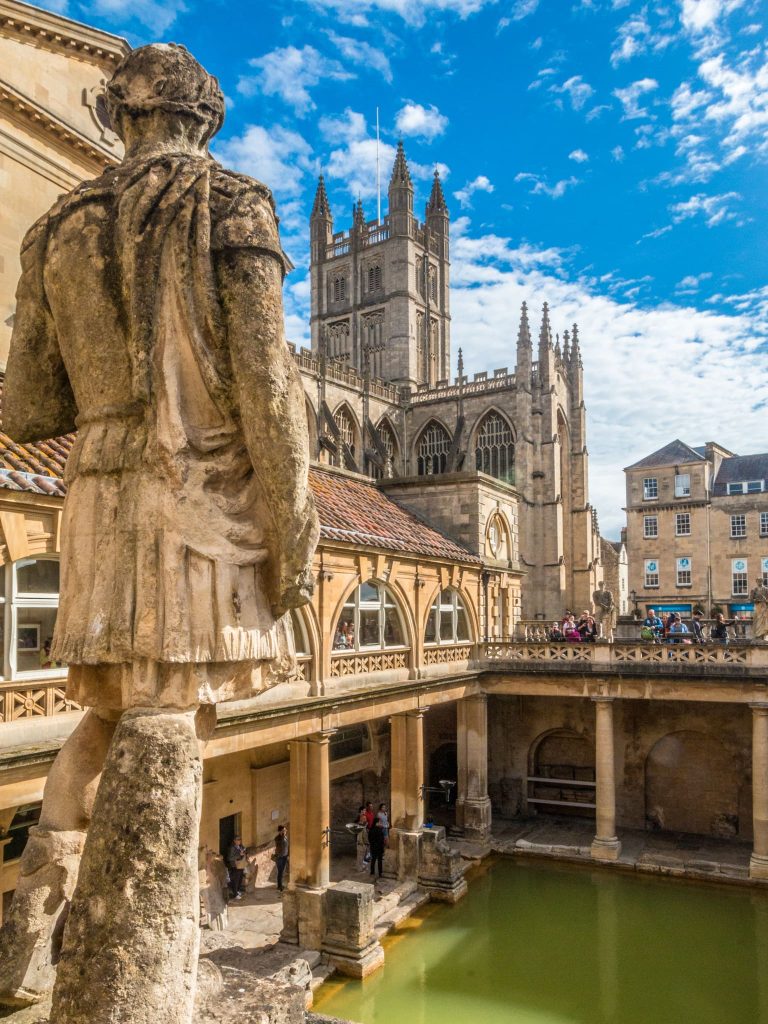 The Roman Baths and Cathedral in Bath, Somerset. This is one of the must-see sightseeing attractions in Bath and a wonderful way to spend an additional day at the end of your walking holiday in the Cotswolds.