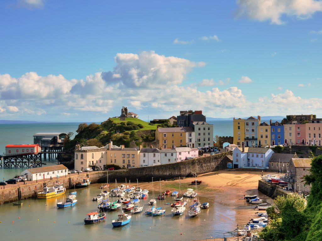Tenby Harbour and Castle Hill in Wales on a sunny day, a coastal favourite when planning the best time to travel the UK